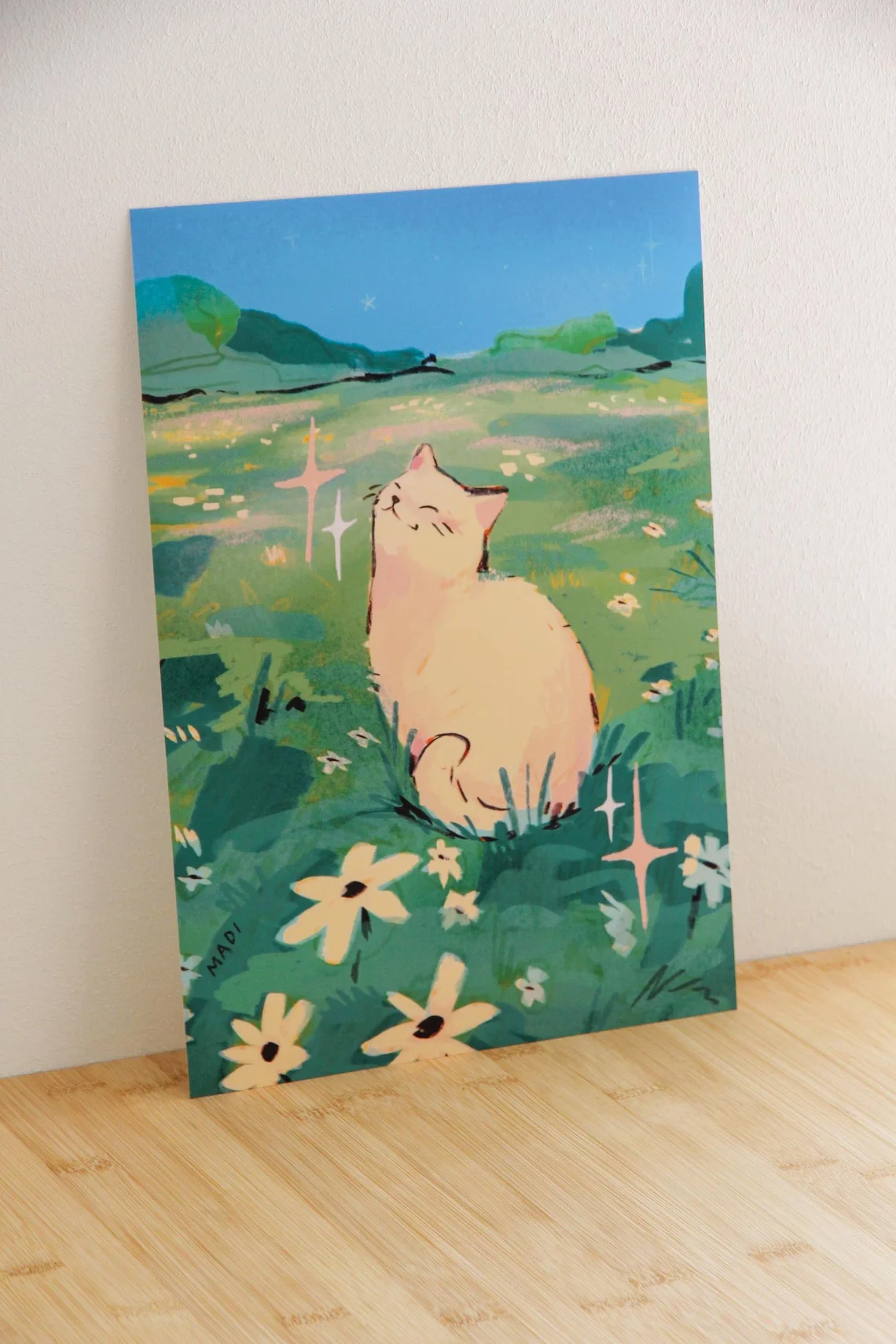 Serene Meadow Cat Wall Art - Ethereal Print Celebrating Feline Joy. The Vibrant Green Meadow and Sparkling Sky Create a Peaceful