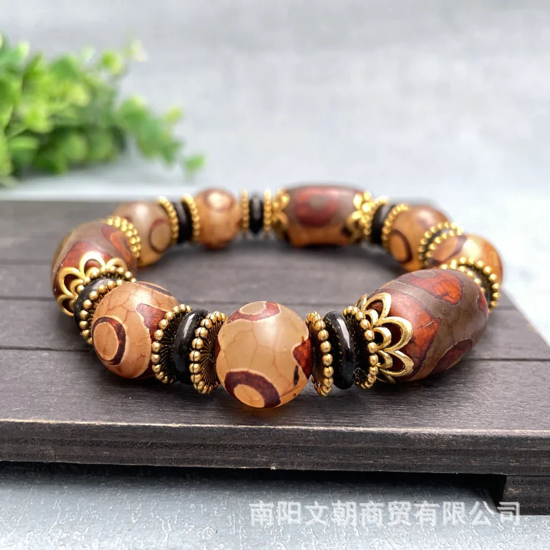 Men’s and women’s bracelets featuring three-eyed Dzi beads, large drum-shaped beads, and green dragon-patterned chalcedony and a