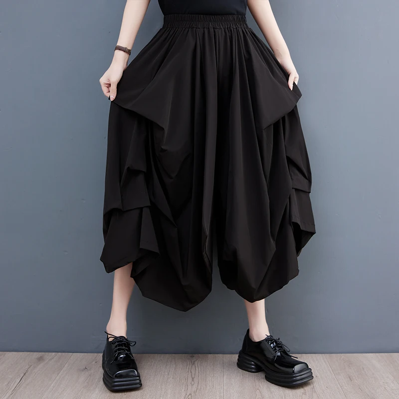 Szerokie spodnie z szerokimi nogawkami, elastyczna talia, plisowana spódnica codzienna, modna, uniwersalna, dobra jakość, możliwość warstwowego noszenia, styl do pracy.