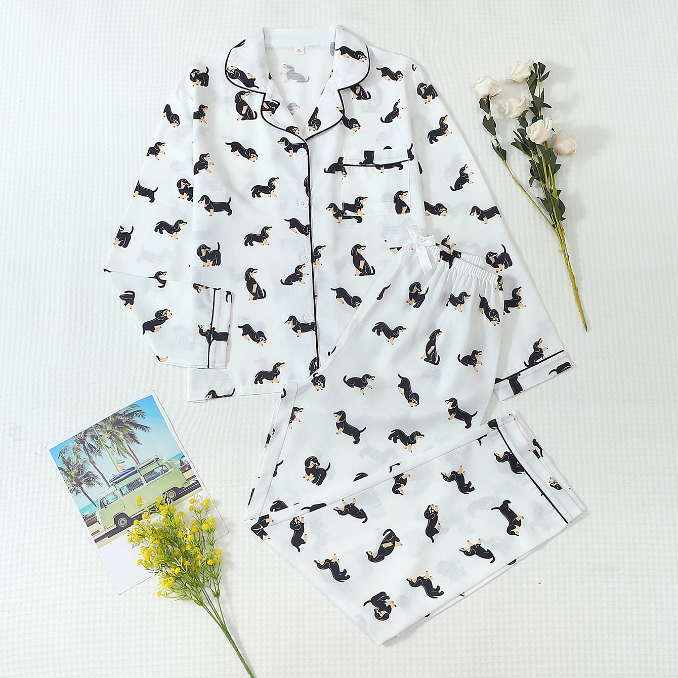 Two-piece comfortable black and brown dachshund print pajama set for women, featuring a collared button-up top and bow-tie pants, suitable for home use