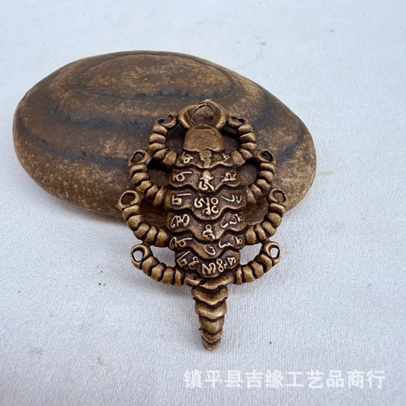 Tibetan-style brass scorpion pendant, featuring a wrathful deity from Tibet and Nepal, a nine-headed scorpion, and a copper scor