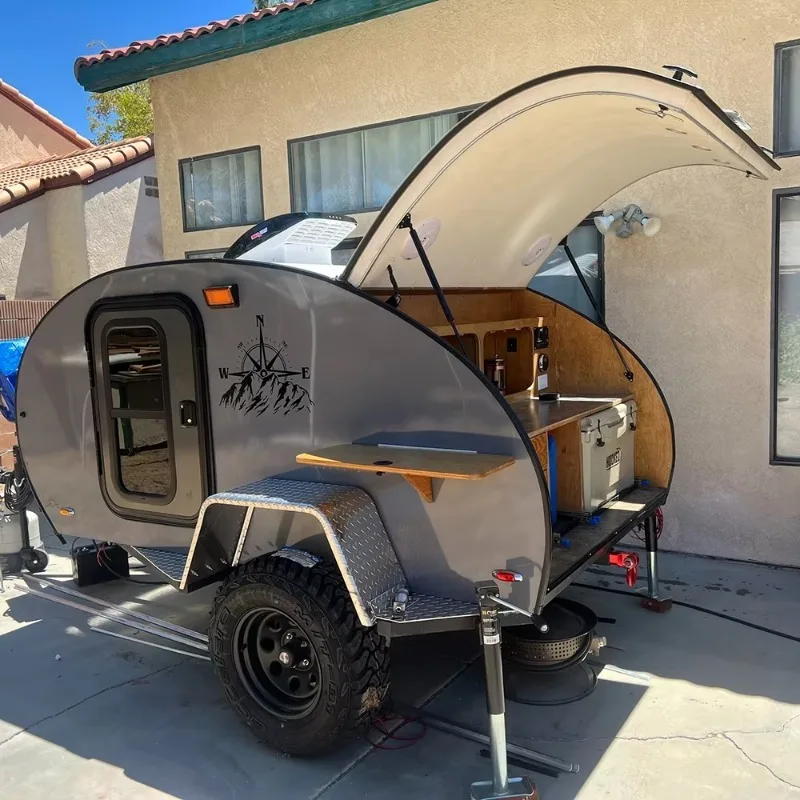 Custom Factory Built Small Teardrop Camper Trailer with Light Emitting Diodes and Movable Features for Off-Road Travel Trailers