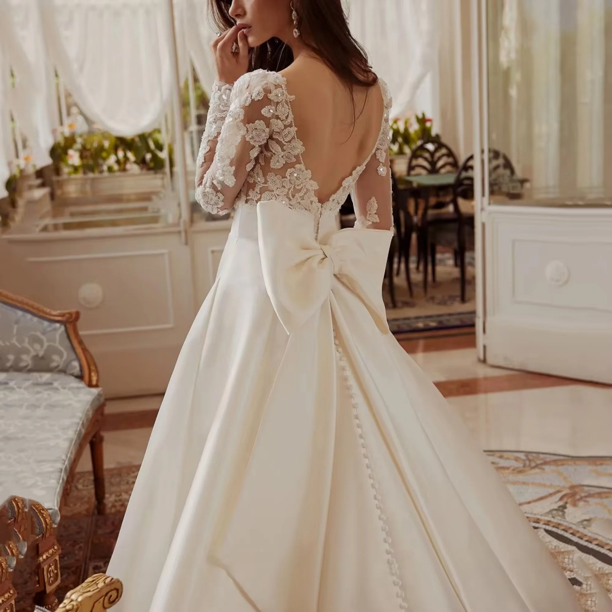 فساتين زفاف أنيقة على شكل حرف a مثيرة بأكمام طويلة بدون ظهر فستان زفاف بفيونكة دانتيل فساتين العروس الفاخرة فيستدو دي نوفيا مخصصة أنيق خط مثير فساتين الزفاف الأكمام الطويلة خلفية فستان العروس الدانتيل قوس فساتين العروس
