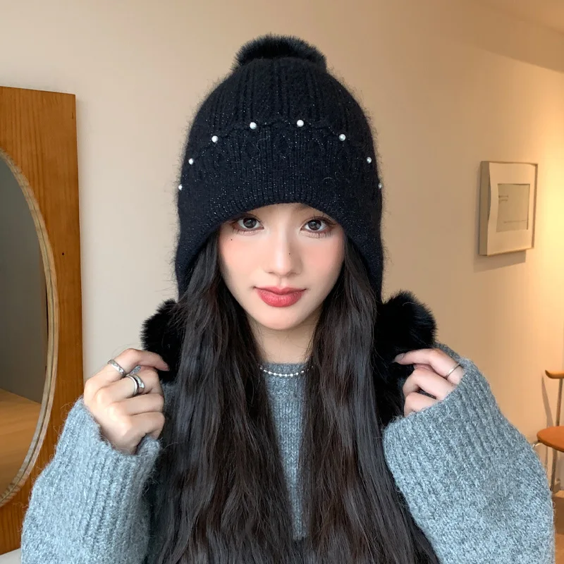 Korean version autumn and winter women's rabbit fur hat. Pearl three-ball knitted wool hat, warm and with ear protectors.