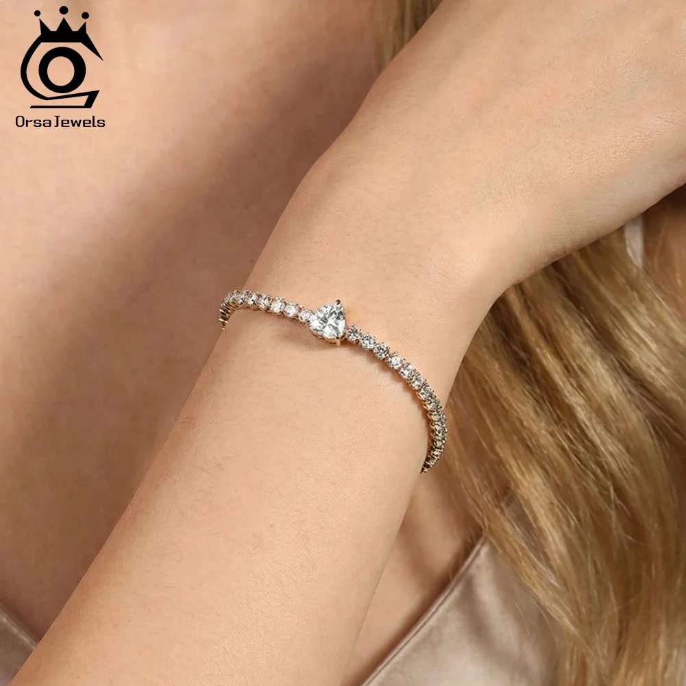 

ORSA JEWELS Stainless Steel 3mm Cubic Zirconia Tennis Bracelet for Women 18K Gold Plated CZ Heart Charm Bracelet Jewelry STKB03