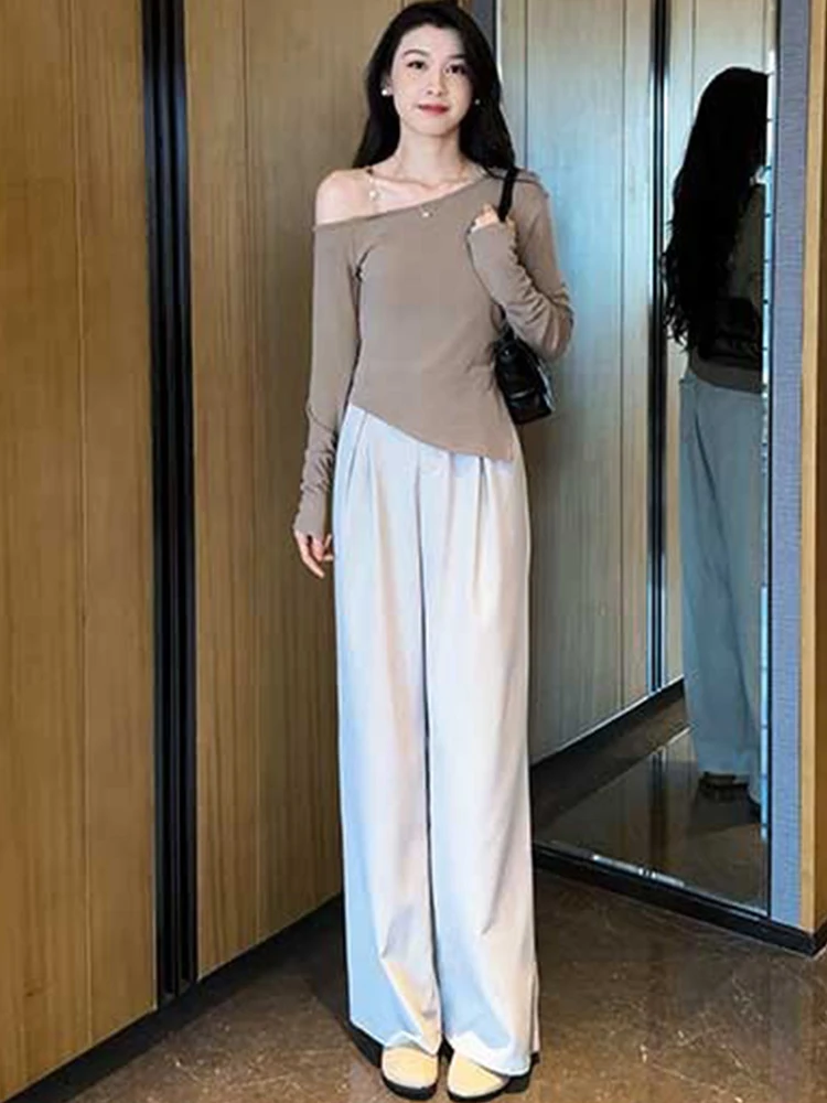 

Модный комплект из двух предметов: топ с асимметричным дизайном и открытыми плечами, утягивающий фигуру, и брюки с высокой талией и широкими штанинами. Коллекция Осень 2024.