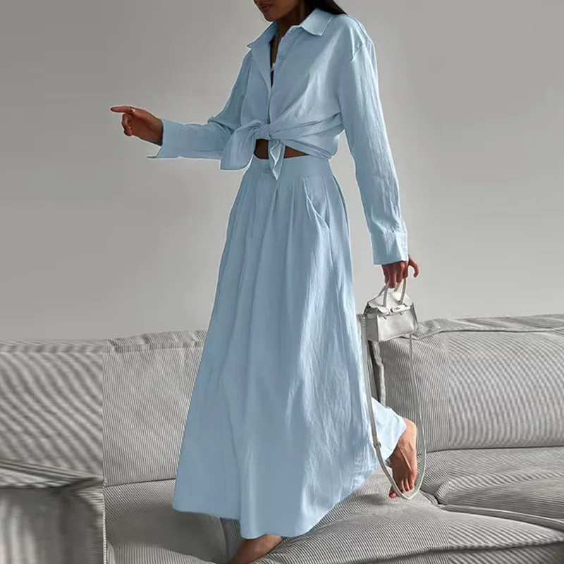 

Осенняя рубашка с длинными рукавами и пуговицами с лацканами и юбки с высокой талией. Женский повседневный однотонный комплект из двух предметов. Весенний полый офисный костюм с завязками.