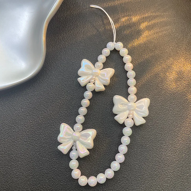 Cadena de teléfono de diseño original |   Cadena rosada del teléfono del arco de la perla, cadena CCD del teléfono del grano de la muchacha para el encanto lindo del teléfono del iPhone 17 16