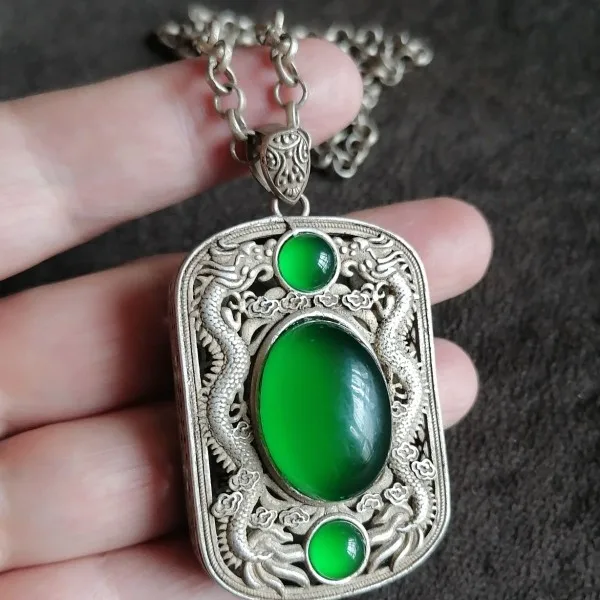 

silver-inlaid full-green jadeite cabochon pendant necklace with auspicious ruyi design from the Tibetan area's returned items