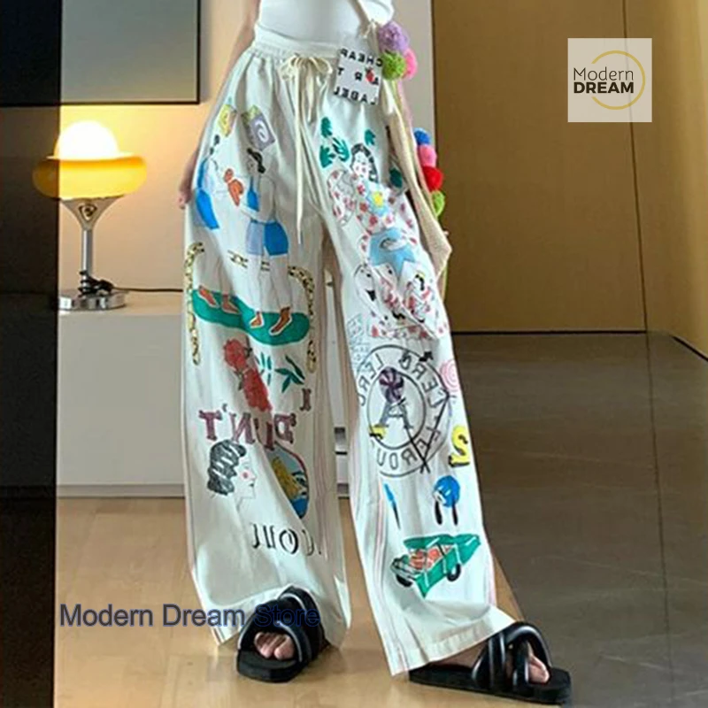 Korean version of simple minority cartoon graffiti printed pants women's summer new plus size design high waist casual pants.