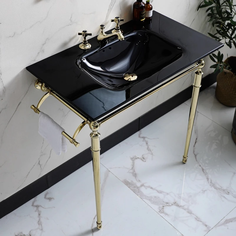 Black glass washbasin with gold copper metal bracket for