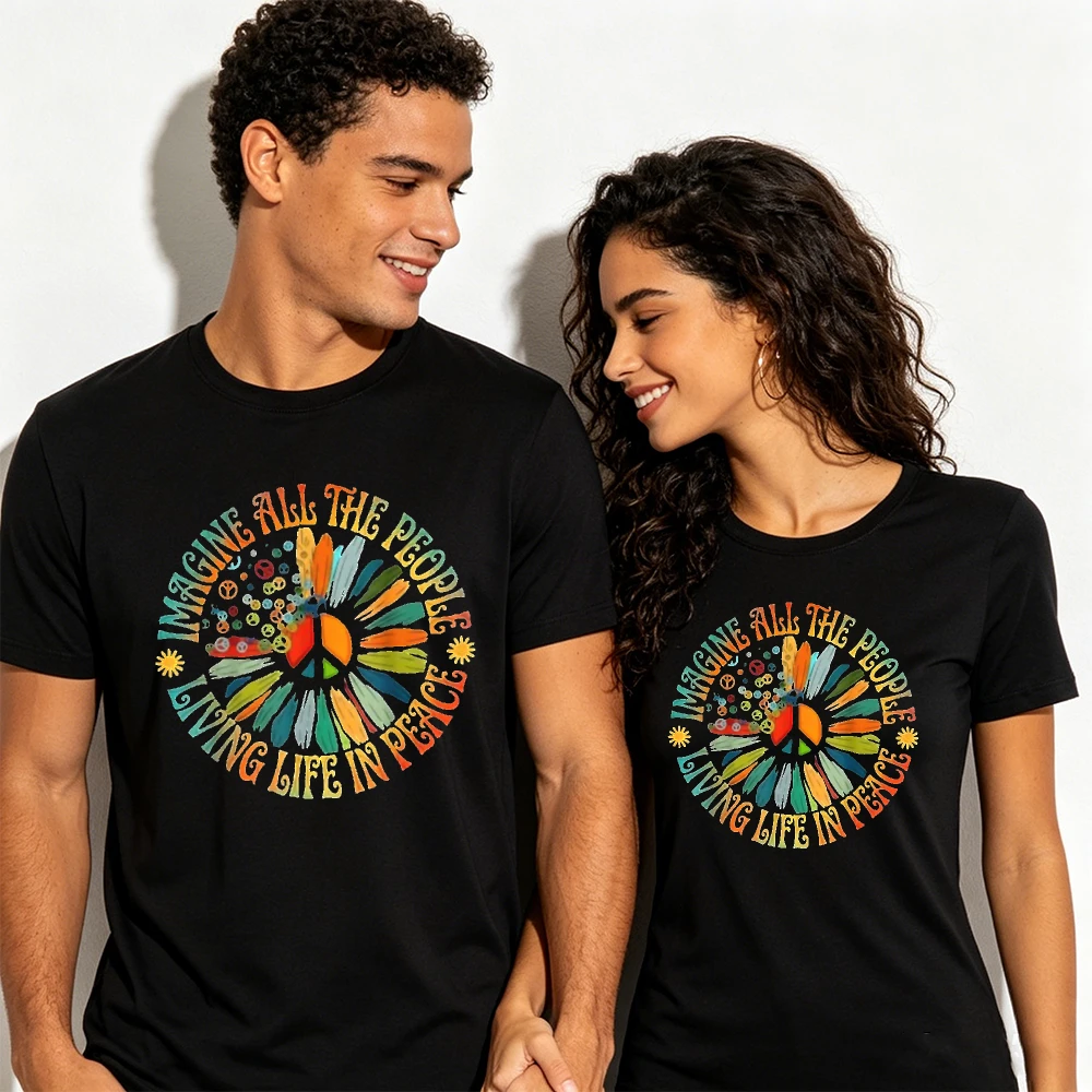 Black vintage T-shirt with large multicolor hippie flower print and text reading “IMAGINE ALL THE PEOPLE LIVING LIFE IN PEACE.”