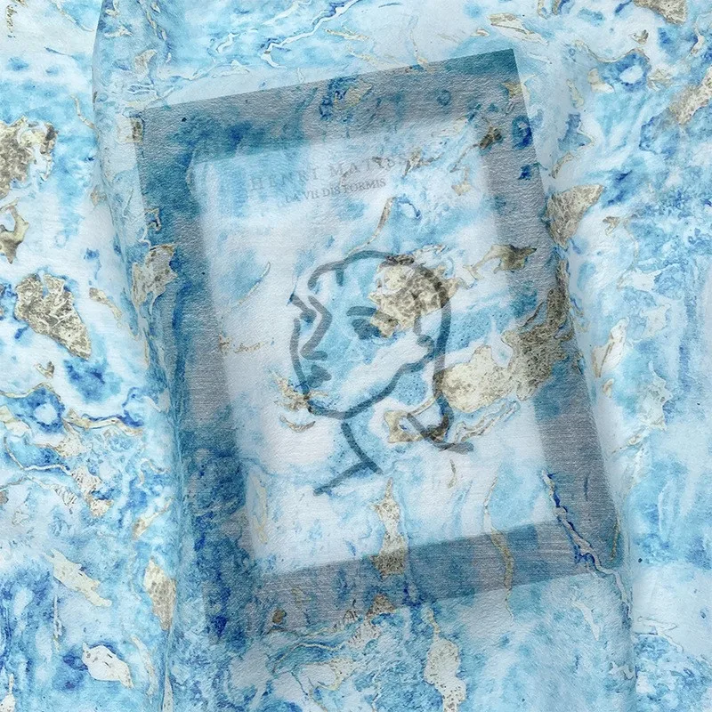 The semi-transparent skirt fabric made of blue ocean tie-dyed printed silk linen and is