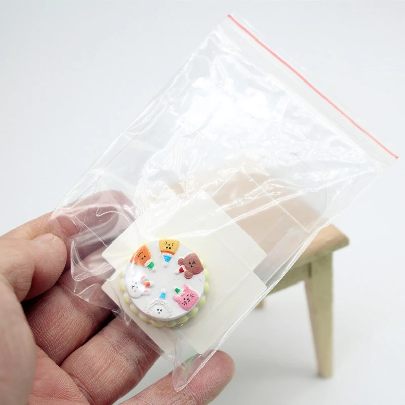 Miniatuur 1/12 poppenhuis cartoon cake in transparante container, poppenhuis voedsel simulatie accessoire, creatief decorstuk.