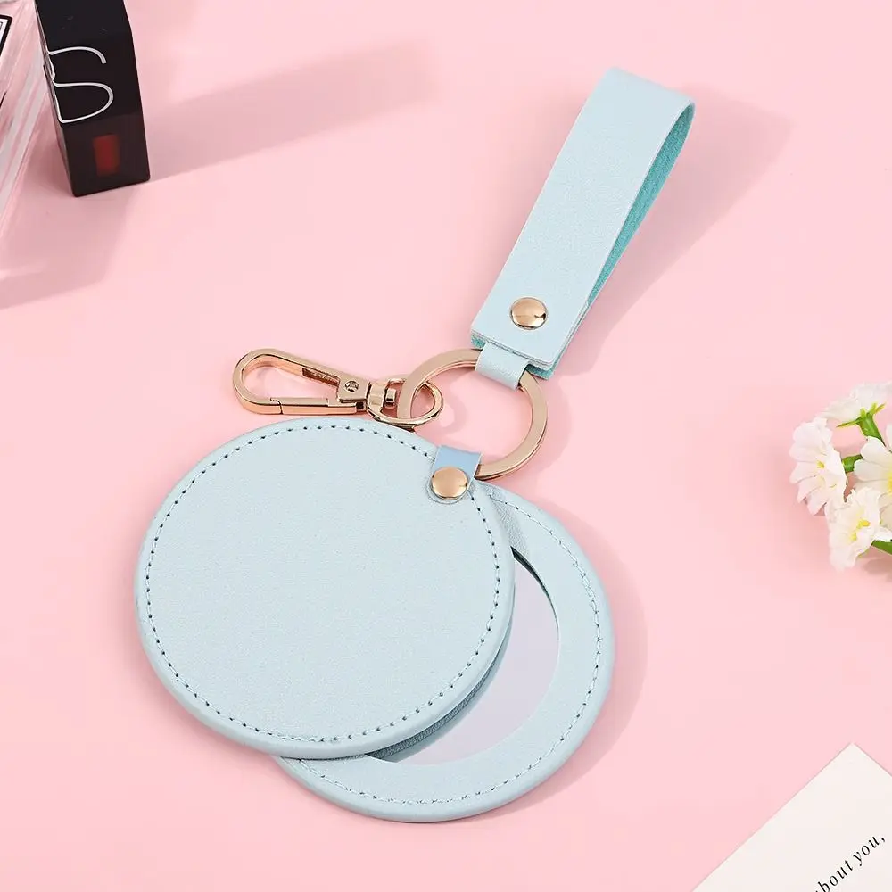 Mode PU-leer kleine make-upspiegel Ultradun lichtgewicht schattige kleine spiegel Draai ronde draagbare reisspiegel Zakformaat