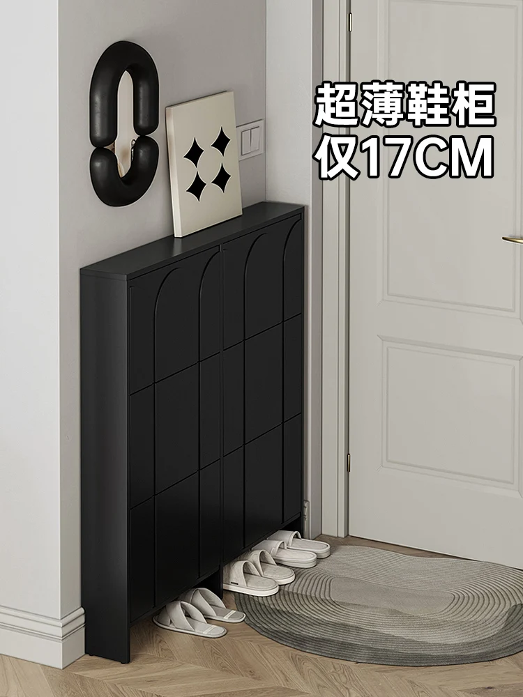 Ultra-thin shoe cabinet Narrow tipping bucket type narrow cabinet behind black door at the entrance of corridor.