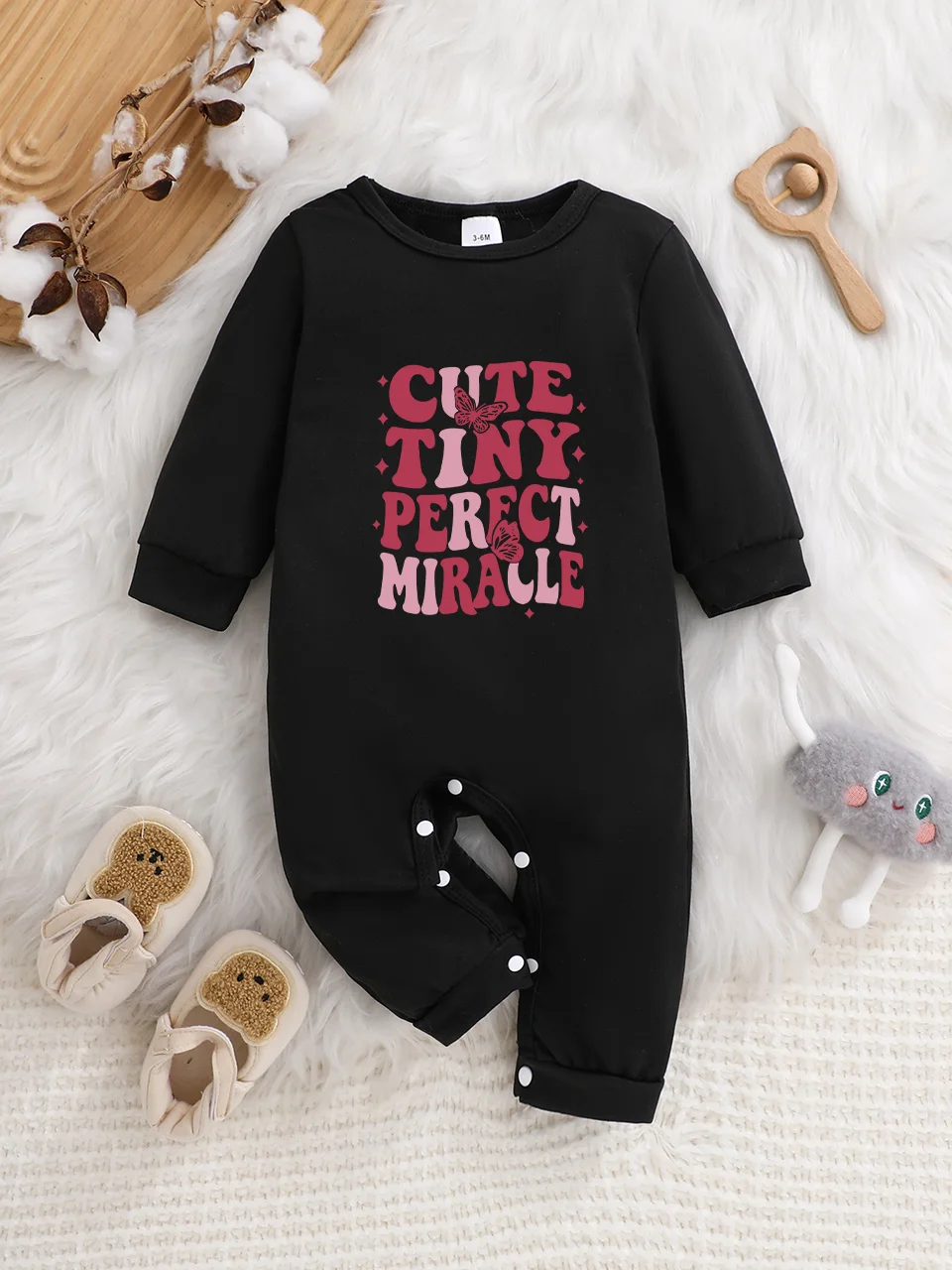A baby long-sleeved onesie with interesting letter prints. It features a buttoned design for easy putting on and taking off, and