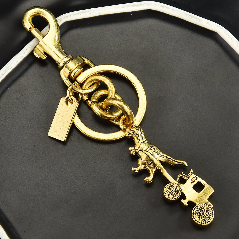 

2025 New alloy creative carriage bag pendant, female dinosaur pulling a carriage keychain pendant