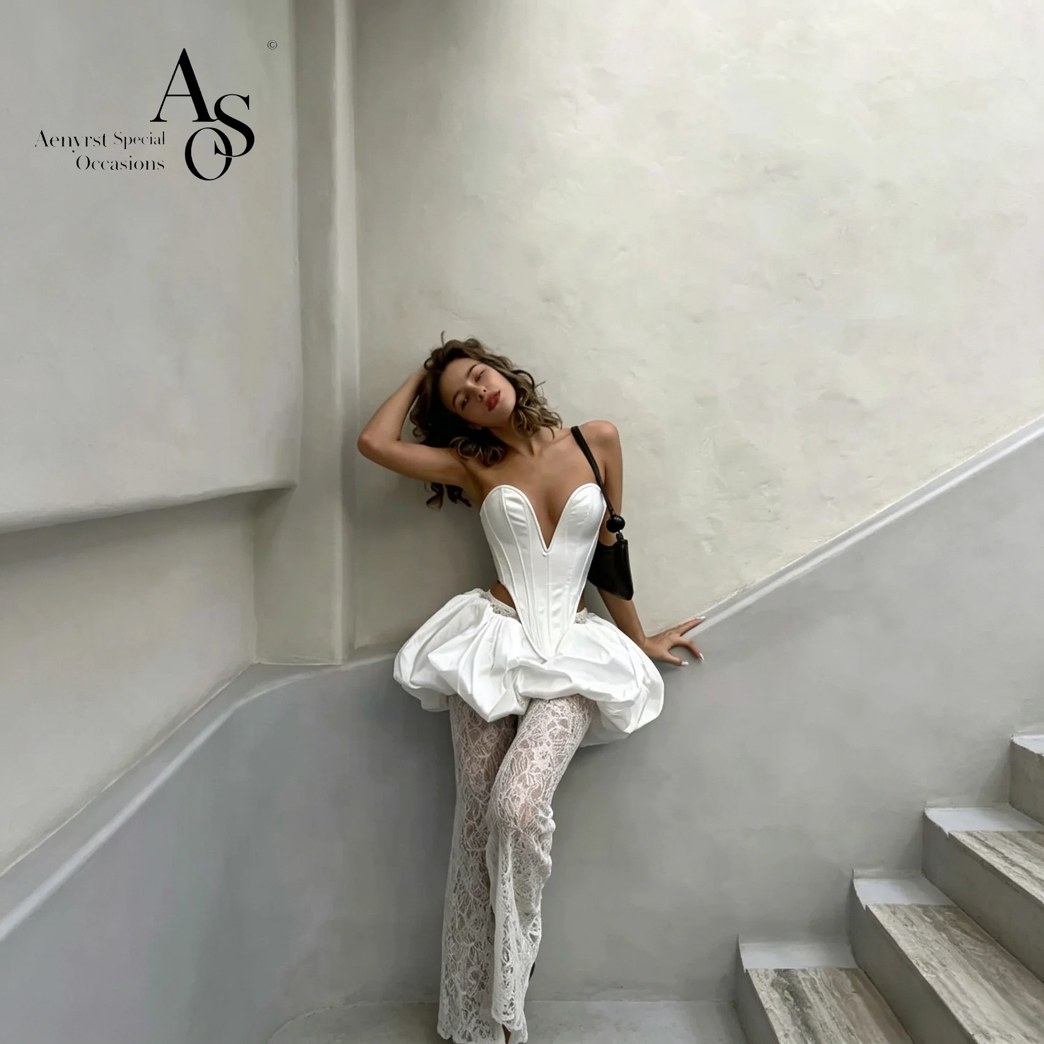 Trendy white strapless sleeveless lace knee-length bubble dress for parties, paired with matching lace pants.