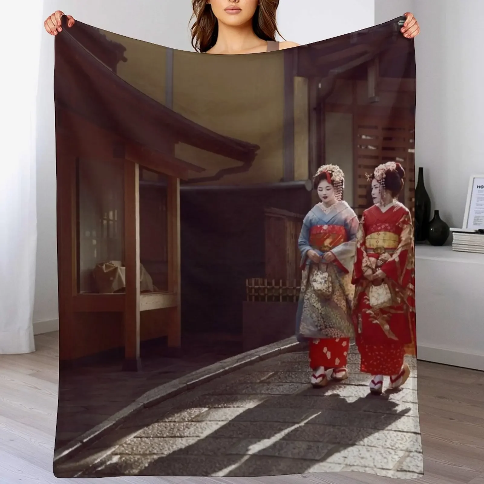 

Two Geisha apprentices Maiko in bright kimono walking down an old street in Kyoto Japan art photo print Throw Blanket
