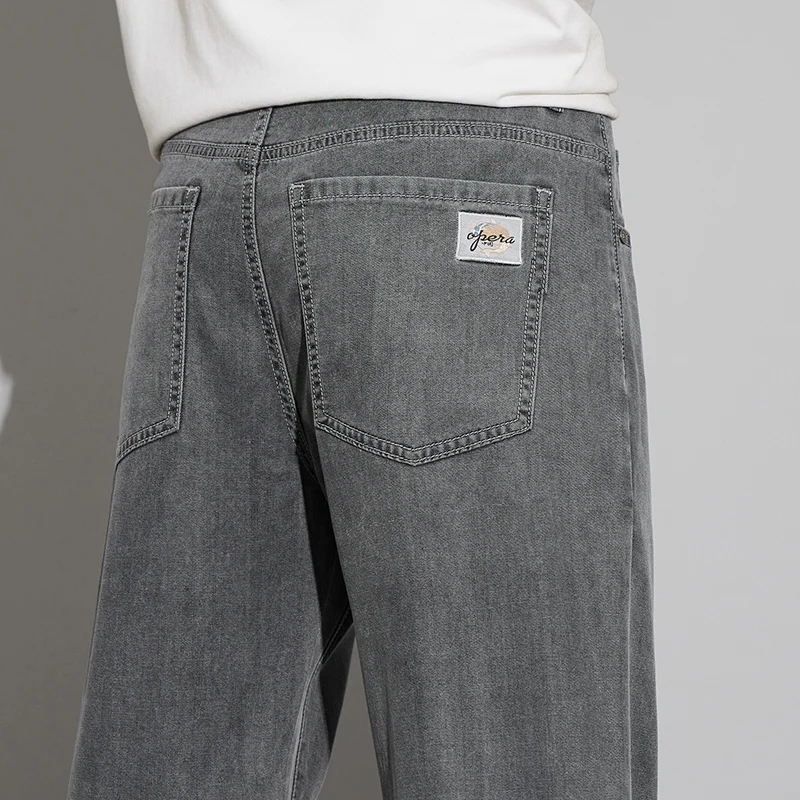 2025 Lyocell verano pantalones vaqueros finos de los hombres de cintura alta sueltos cómodos rectos elásticos pantalones vaqueros de negocios pantalones masculinos
