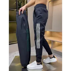 Pantaloni sportivi Slim Fit sottili e versatili da uomo Casual nuovi estivi pantaloni asciutti a flusso alla moda rilegatura delle gambe abbigliamento uomo pantaloni da uomo