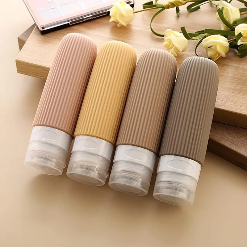 4-teiliges Set Reiseflaschen für Toilettenartikel, Auslaufsichere Quetschbare Reisebehälter für Shampoo und Conditioner, Tragbare Nachfüllbare Behälter
