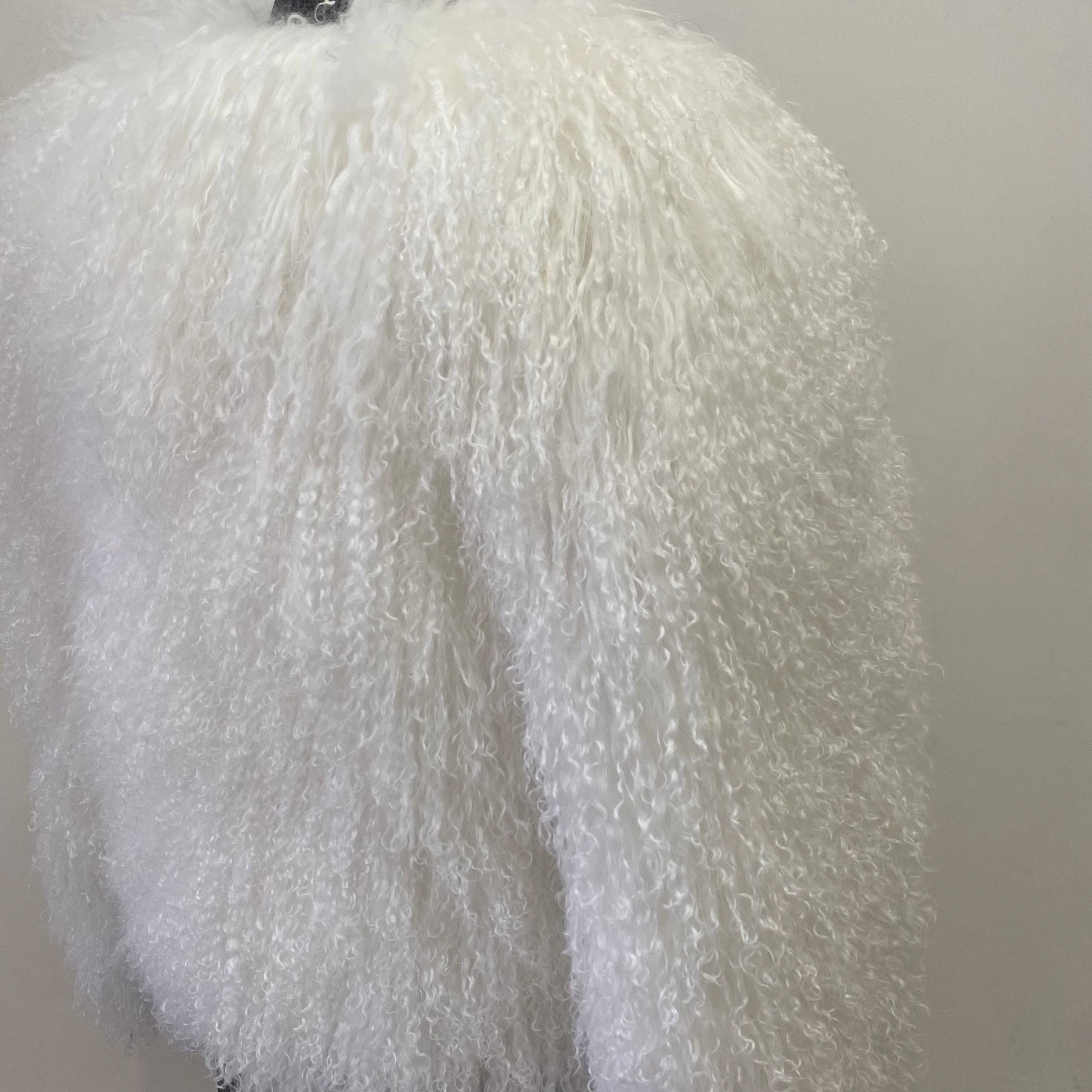 A fashionable and luxurious winter street-wear coat made of natural Mongolian sheepskin, providing warmth and comfort.