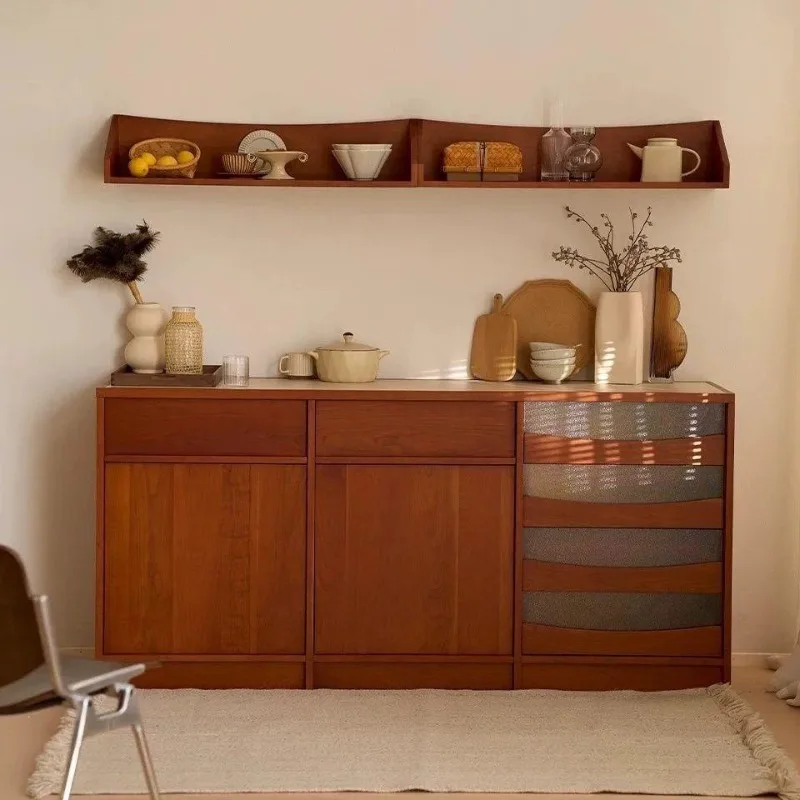 Cherry-colored dining side antique kitchen cabinet against the wall, solid wood side cabinet