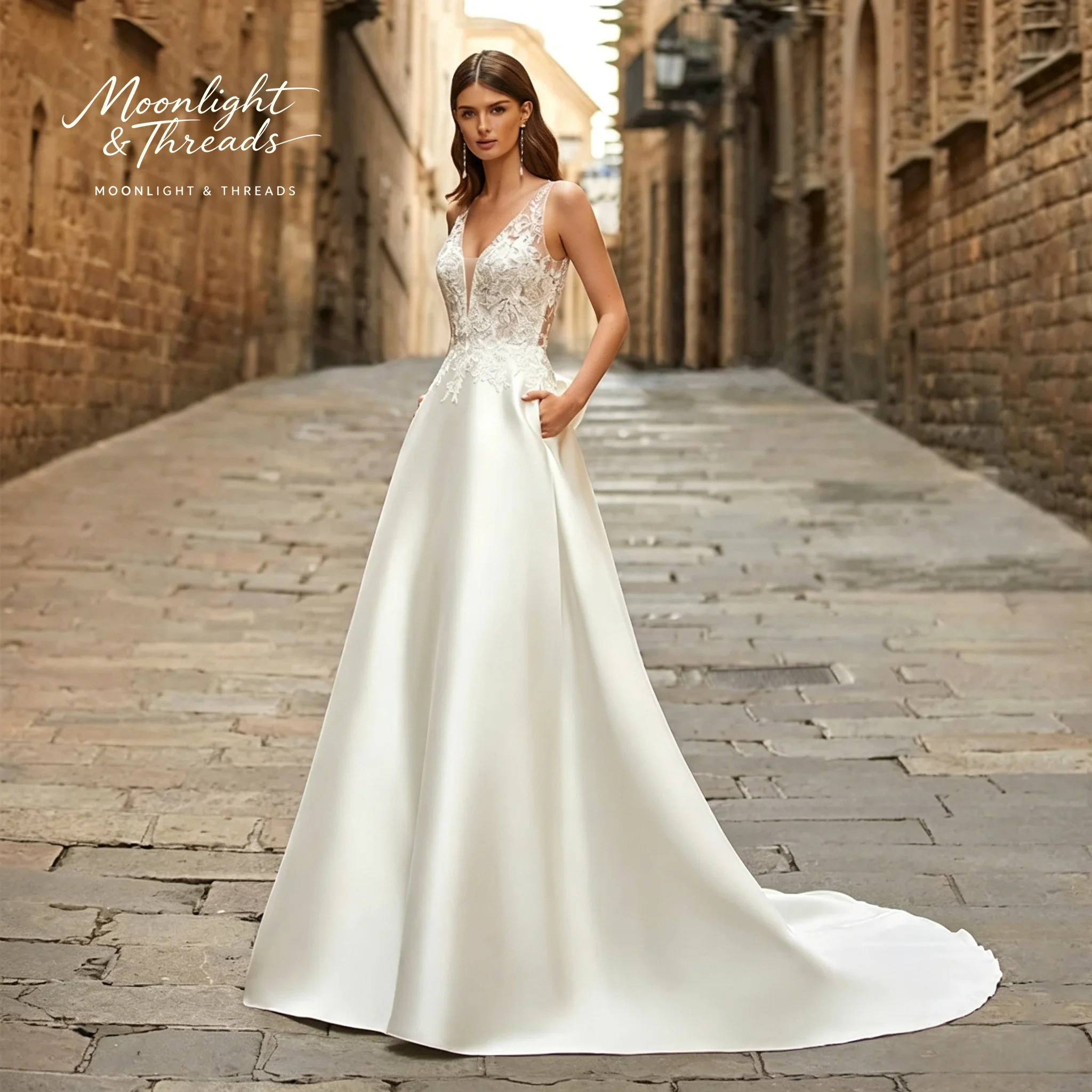 

Ivory satin floor-length formal wedding gown featuring a strapless bodice A-line skirt and French cut-out lace detailing