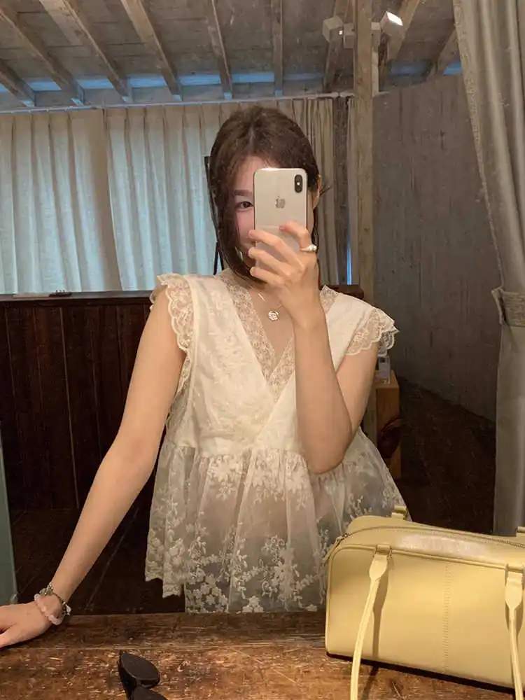 

Clothland Women Sweet White Lace Blouse V Neck Embroidery Transparent Shirt Female Chic Sexy See Through Tops WA319