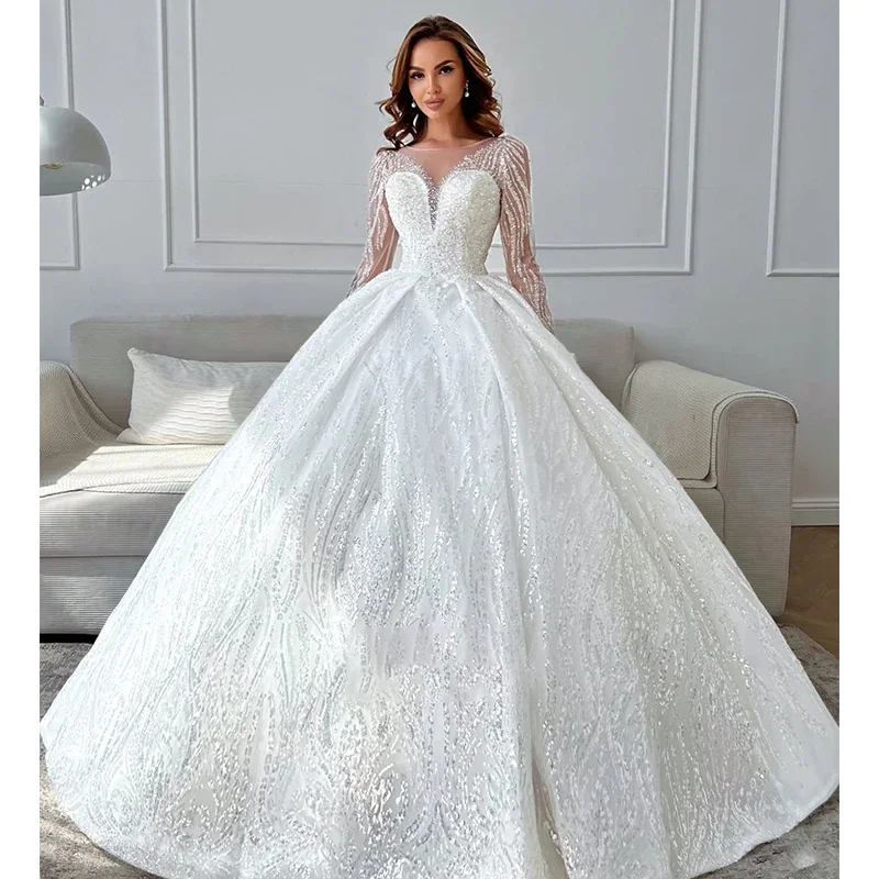 Lussuoso abito da sposa da donna bianco a trapezio in pizzo con perline 2026 Abito da sposa sexy con colletto trasparente a maniche lunghe personalizzato