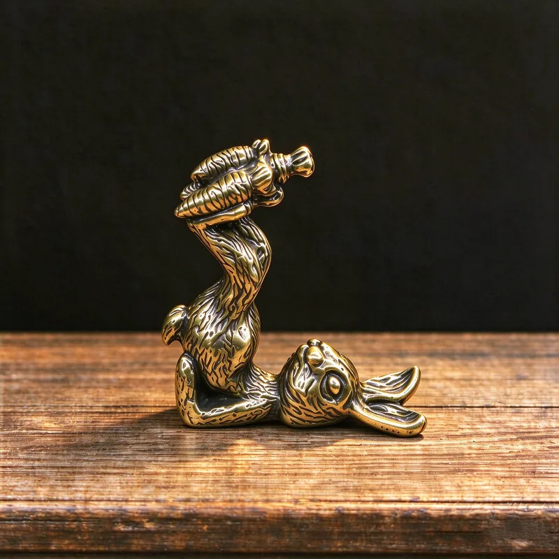 Brass retro-style distressed finish playful rabbit kicking a carrot sculpture copper handicraft