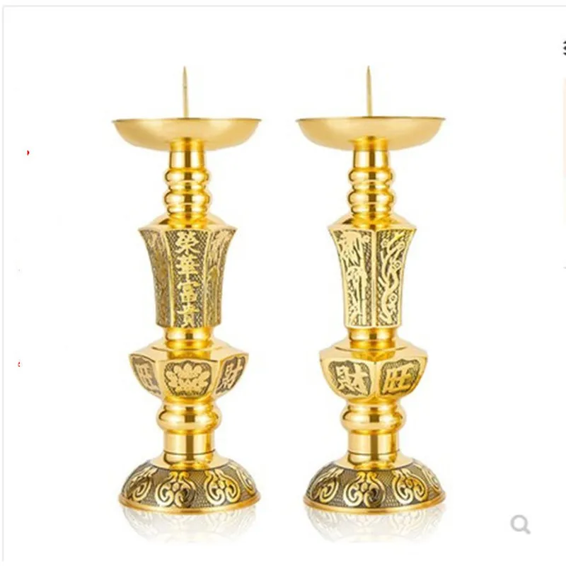 A pair of brass candlesticks with carved designs, candle holders for prosperity and wealth, candle holders for offering to Buddh