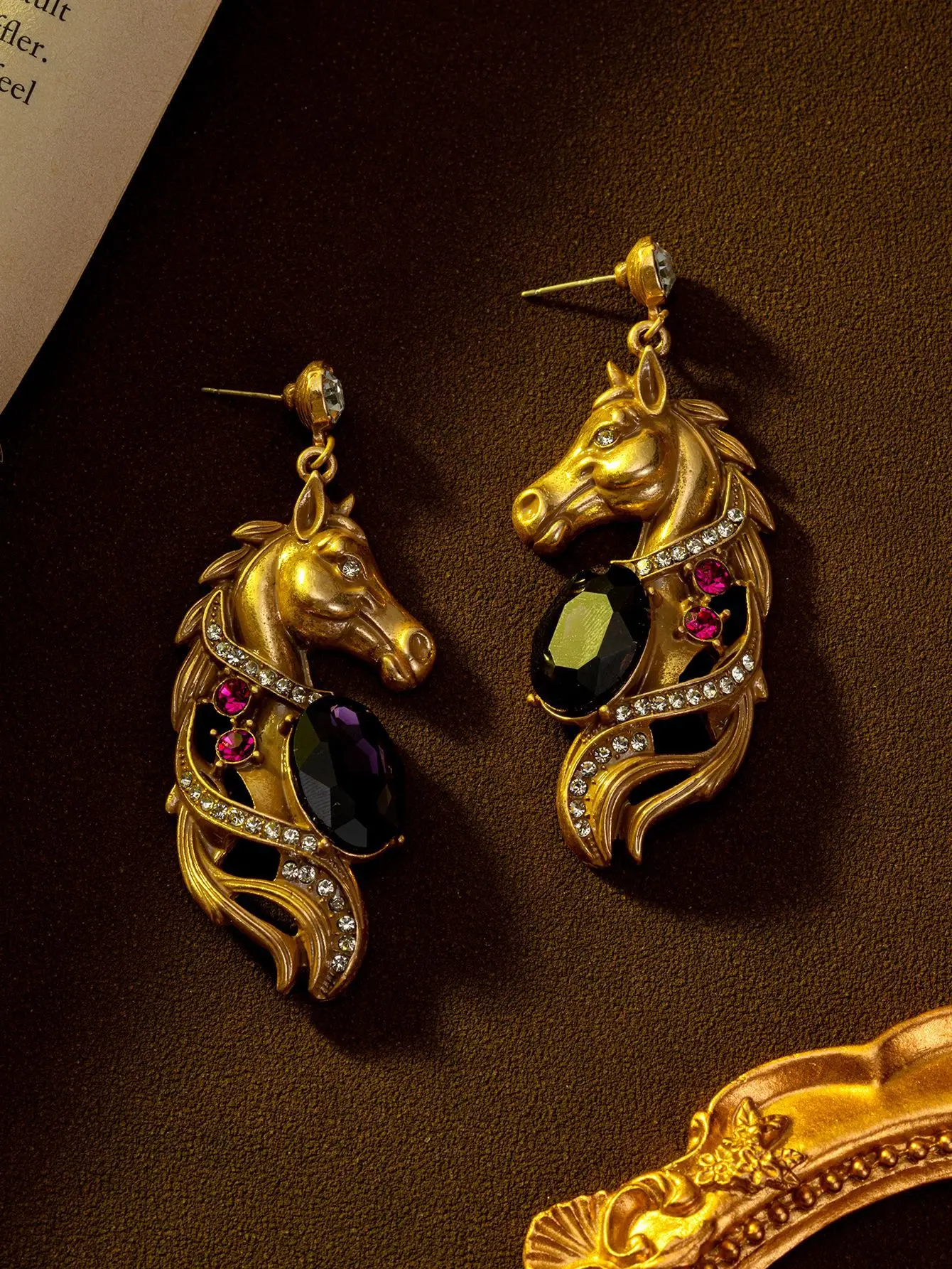 

Medieval classical earrings carved with animal horse heads