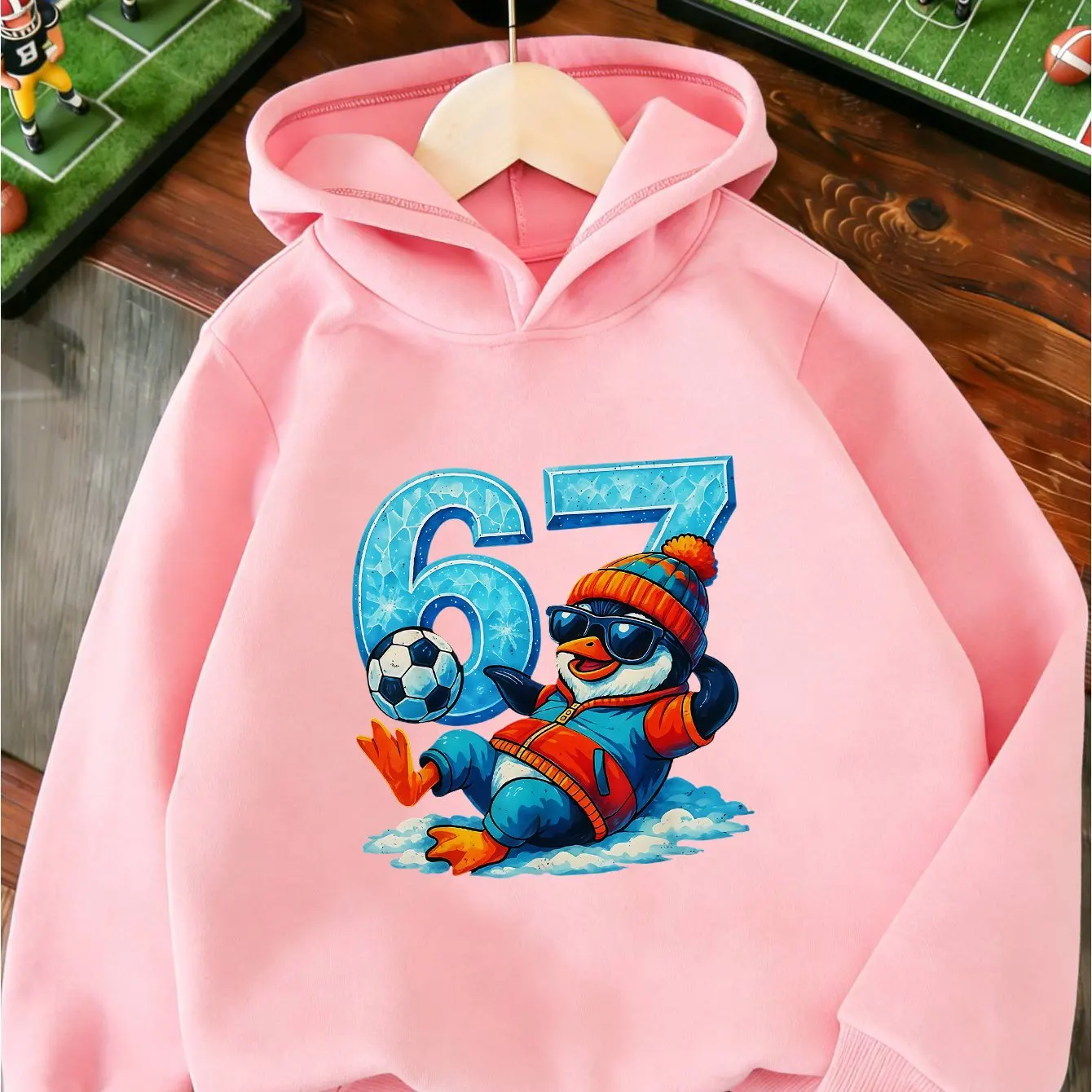 New trendy hooded sweatshirts for boys and girls, featuring a penguin print and a fun, quirky design with the number 67.