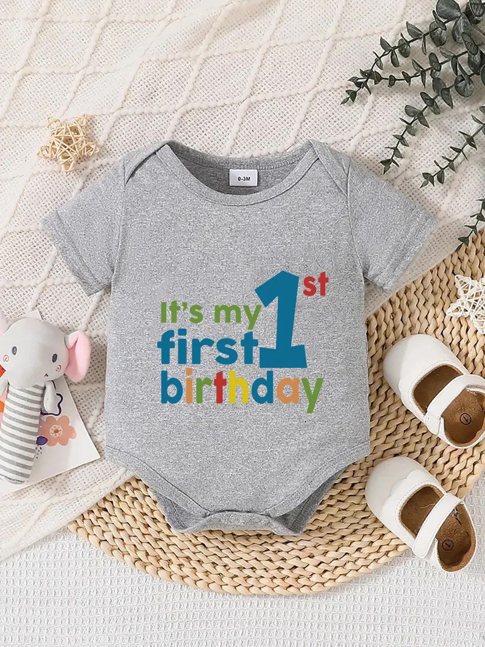 Playful letter-printed baby short-sleeve triangle bodysuit. Button closure for easy dressing, machine washable