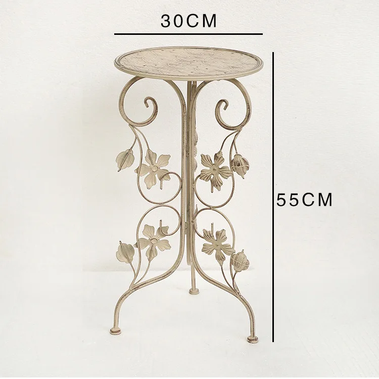 

Floor-to-ceiling flower stand, simple white wrought iron shelf, decorative rack next to the hotel sofa, creative entrance shelf