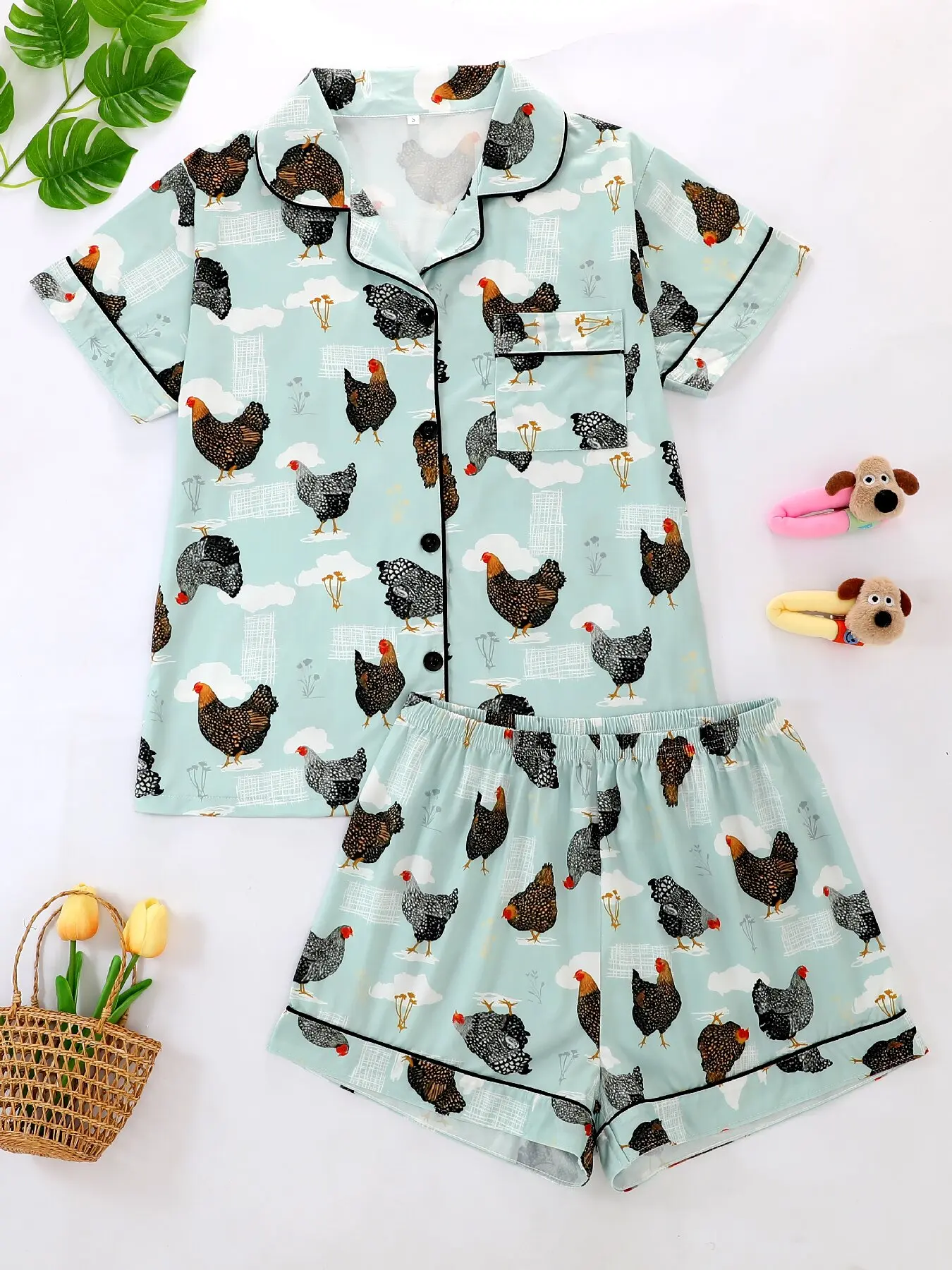 Two-piece pajamas with a floral pattern of a hen, including a button-down short-sleeved shirt and loose stretchy shorts.