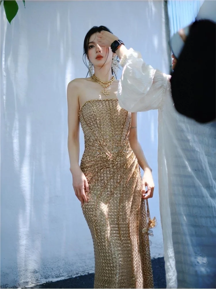 

Heavy sequined strapless and waist-cinching golden dress