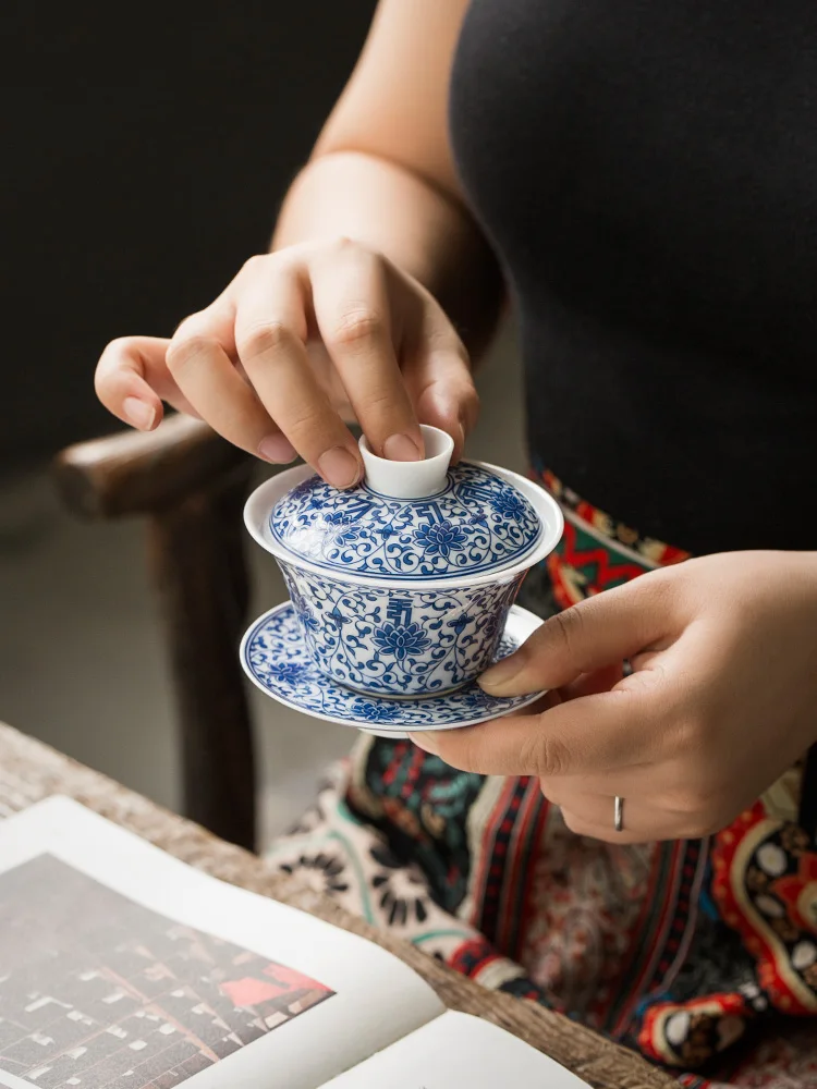 

Traditional Chinese floral totem tea set - blue - and - white porcelain covered bowl with twining lotus pattern. It is light and