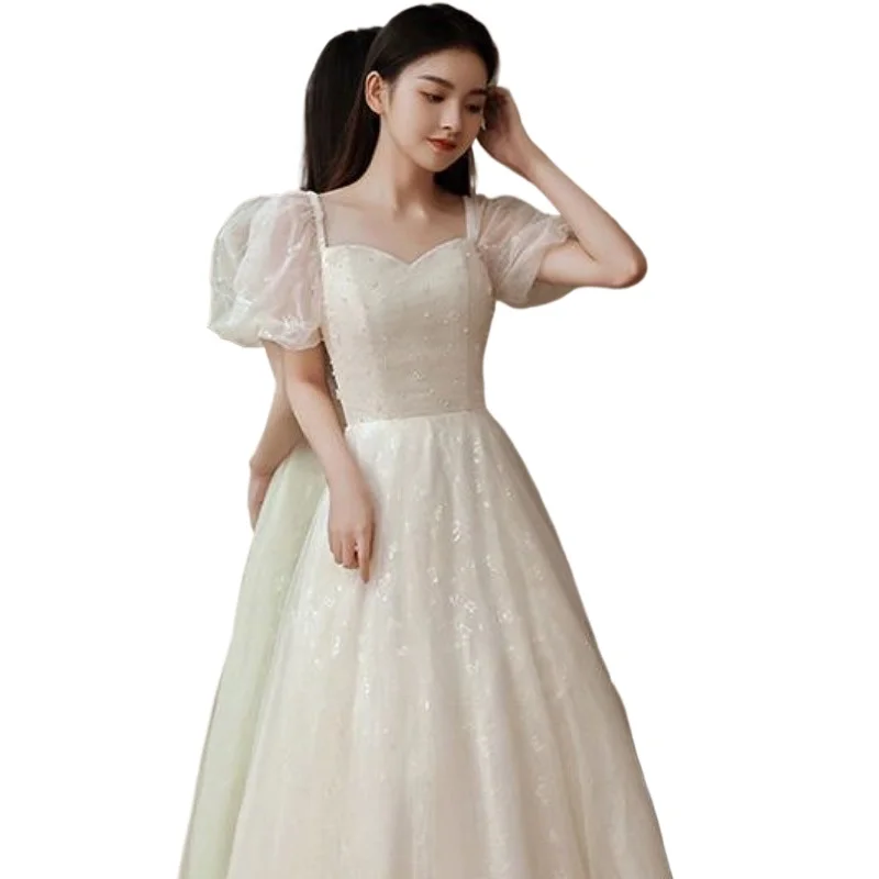فستان سهرة أبيض متخصص نمط جديد مأدبة خرافية مزاجه الراقية نمط طويل الاجتماع السنوي استضافة فستان المرأة الربيع