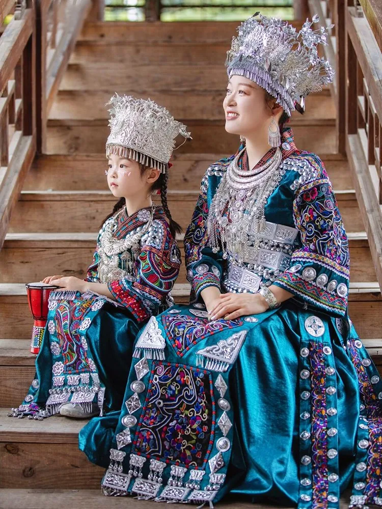 A complete set of ethnic costumes family parent-child wear dark green embroidered top and long ribbon dress