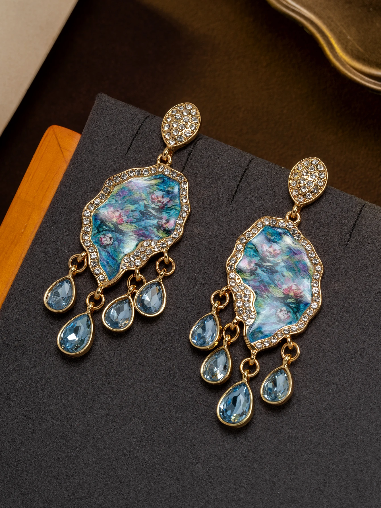 A pair of vintage Monet water lily oil painting earrings with diamond-encrusted blue water drop tassels for women's daily wear and gift giving
