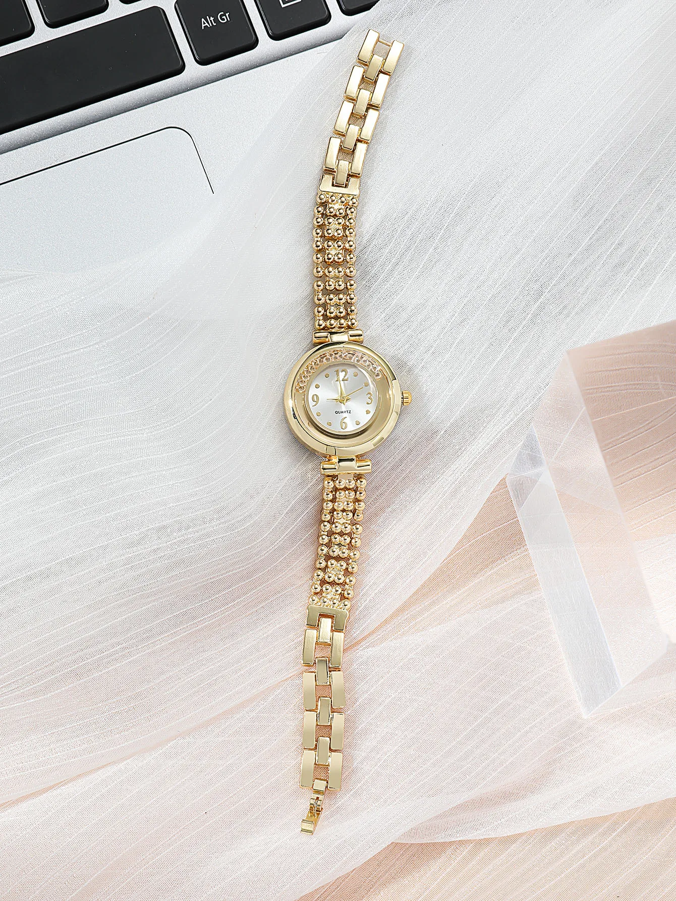 A Gold Women\'s Classic Fashion Quartz Watch With A Ball Bracelet And A Rhinestone Plum Bracelet. Can Be Used For Daily Wear