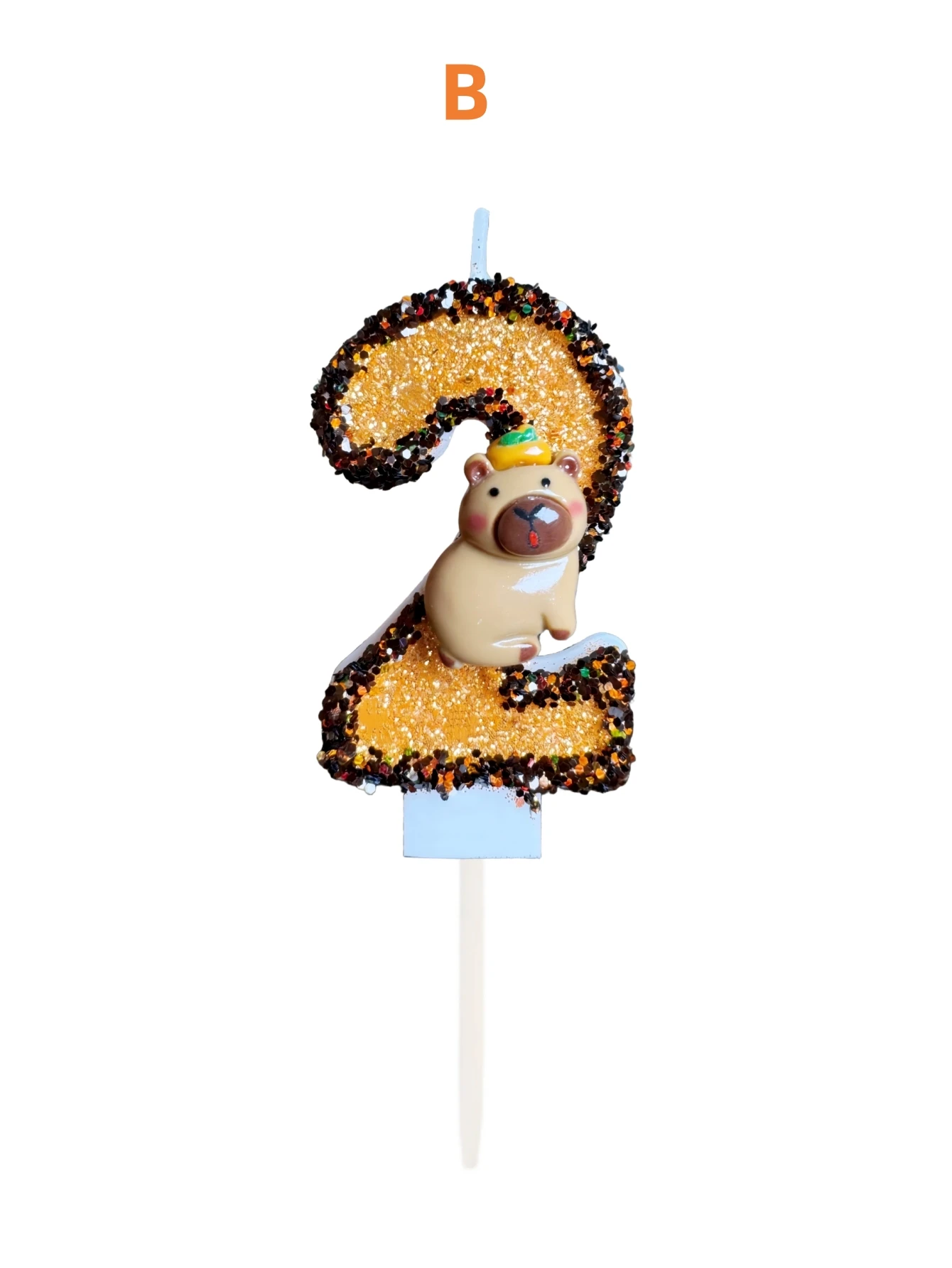 Gold-black Capibara hat with orange-decorated numbers on the birthday candles, as well as holiday and commemorative candles