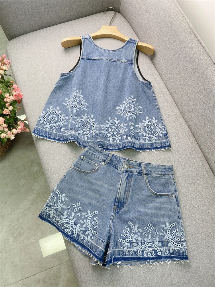 A stylish outfit featuring a blue, niche denim vest with heavy embroidery and fringed shorts