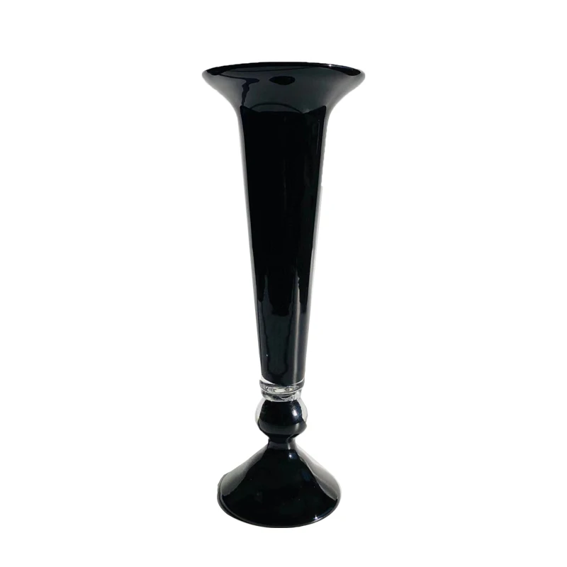 An orange antique vase with a black dual purpose French high foot art vase, candlestick, and floral implement made