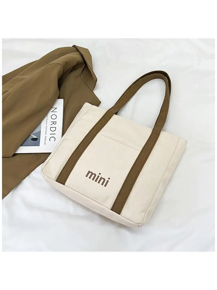 The new trend of the canvas bag shoulder bag the large capacity high level niche appearance design joker handbag shopping tote b