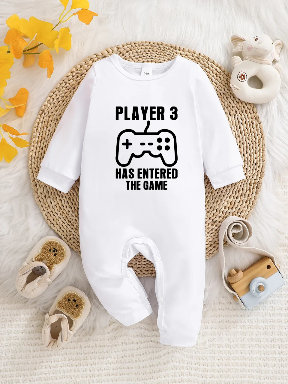 A baby long-sleeved onesie with interesting letter prints. It features a buttoned design for easy putting on and taking off